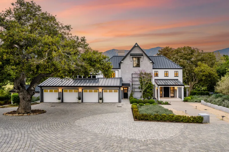 A large house surrounded by green hills